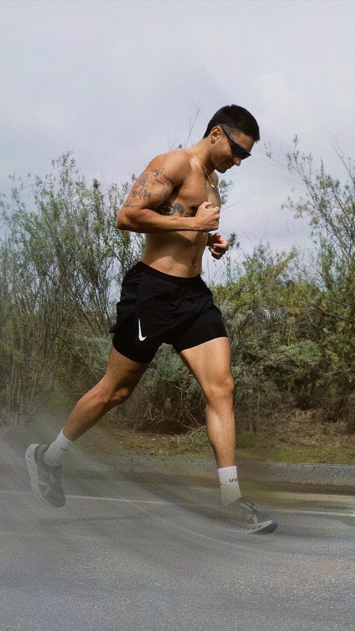 Coach Santi, personal trainer in Costa Mesa, running on an open Orange County road