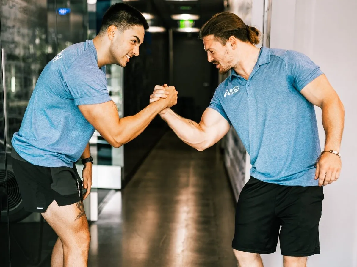 Coach Santi clasping hands with a training partner, small-group and partner personal training in Costa Mesa