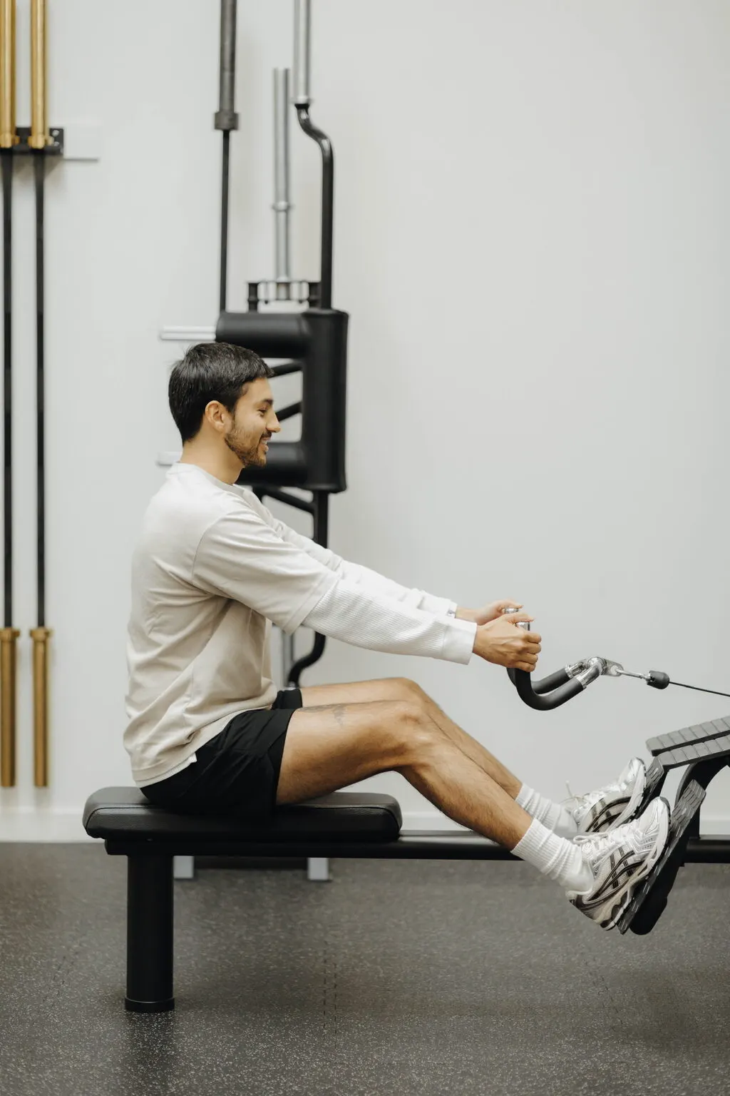 Coach Santi doing a seated cable row at Focus Athletics in Costa Mesa, the strength work that pairs with nutrition coaching for lasting weight loss